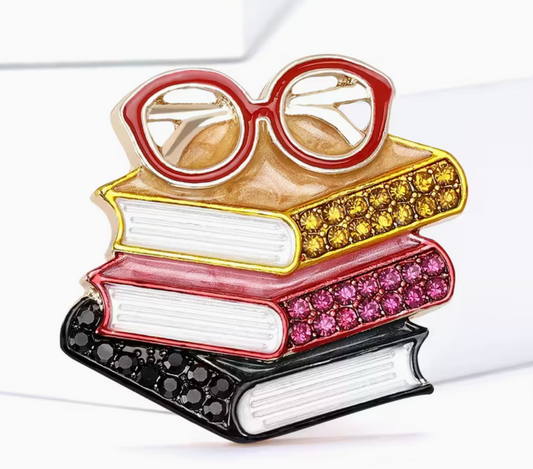Colorful rhinestone brooch featuring a stack of books topped with red glasses