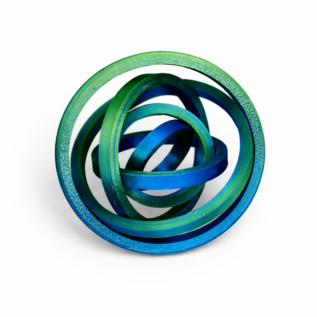 Expanded round 3D printed fidget spinner in green and blue tones forming articulated concentric rings on a white background.