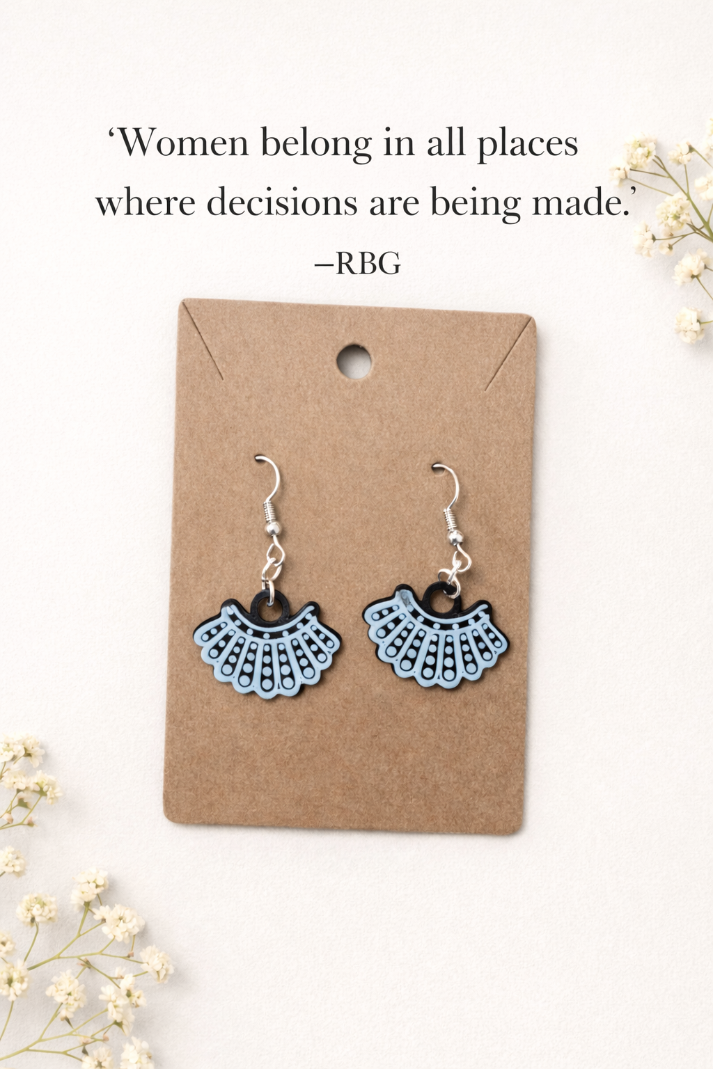 Ruth Bader Ginsburg dissent collar earrings displayed on kraft jewelry card with quote about women belonging where decisions are made.