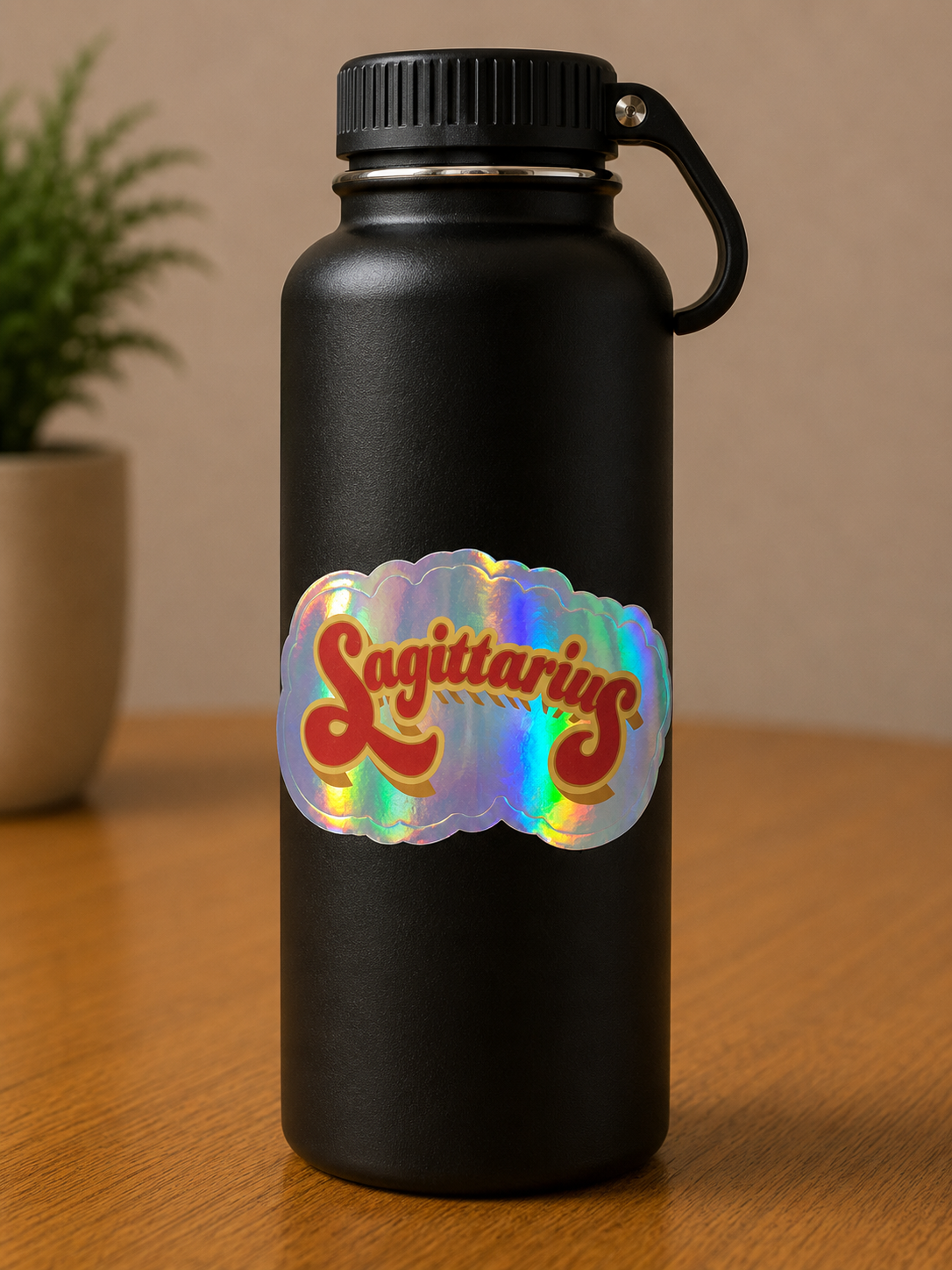 Sagittarius holographic die cut vinyl sticker on a black insulated water bottle with vintage-inspired typography.