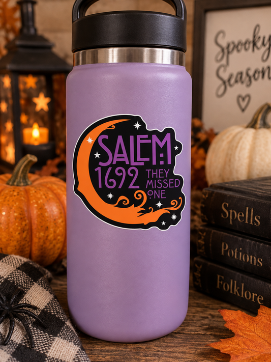 Salem 1692 They Missed One 3 inch Halloween sticker with orange crescent moon purple lettering and stars