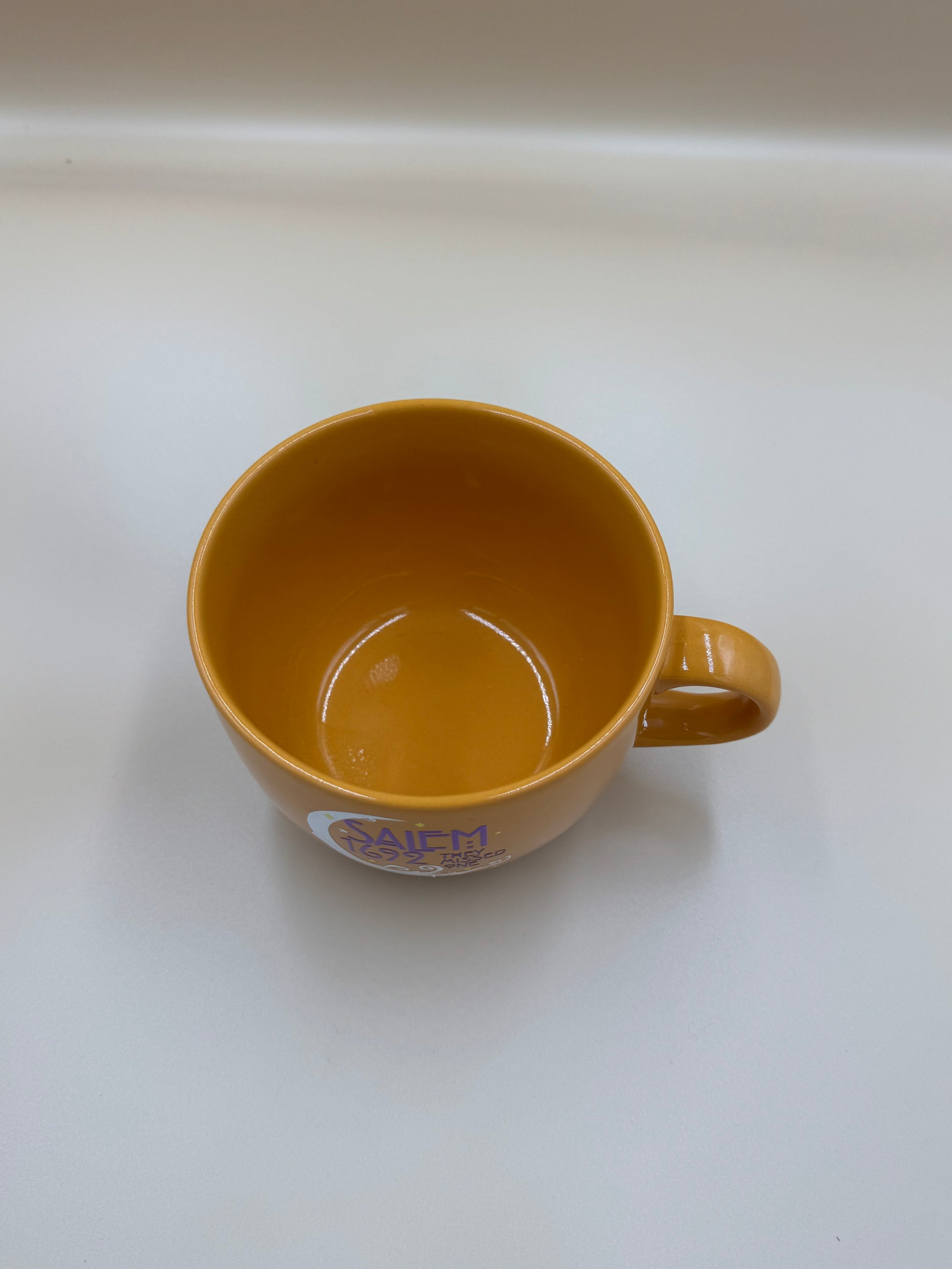 Brown mug with a logo on a white background