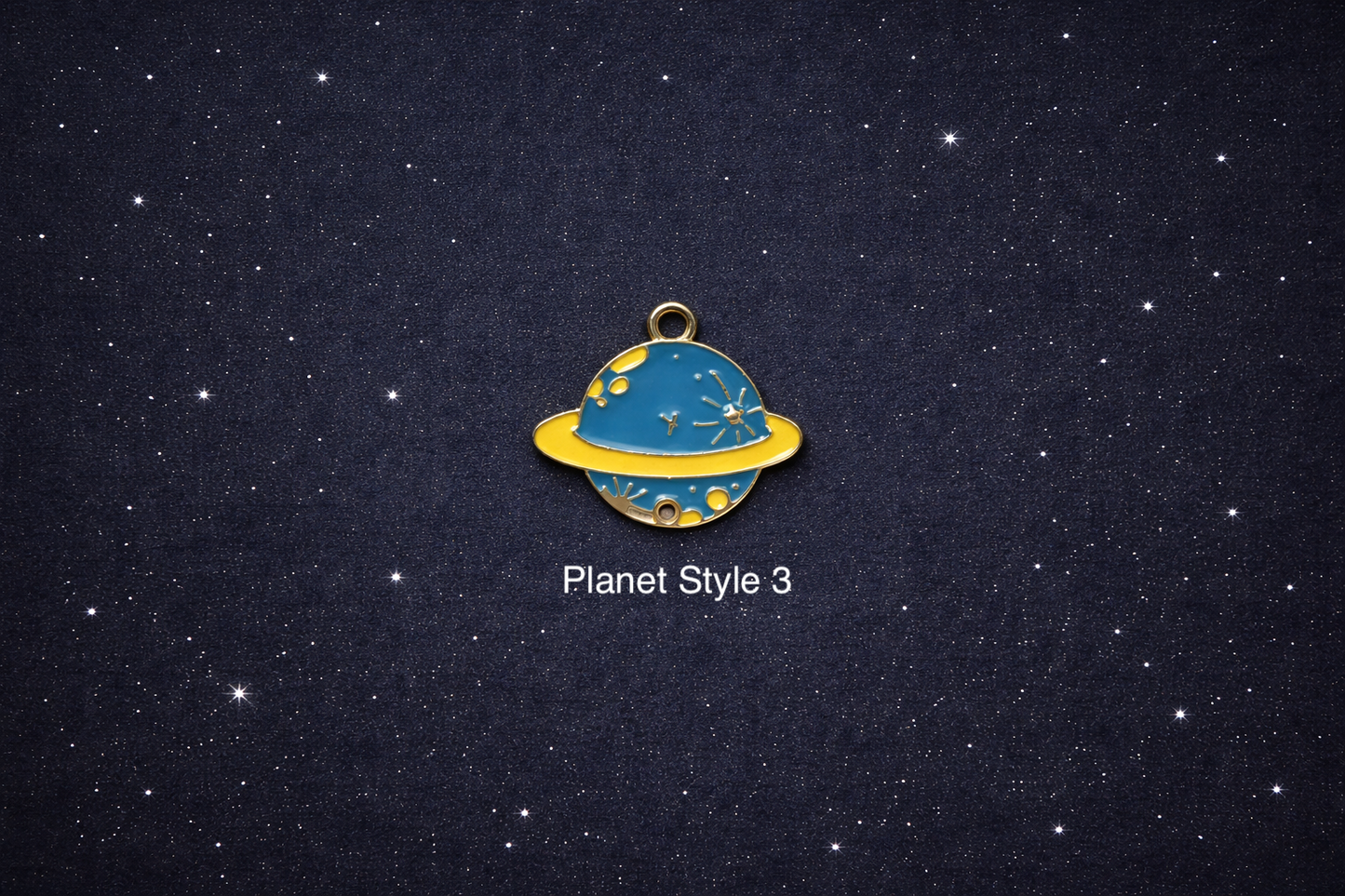 Individual Saturn planet space charm on a dark starry background, suitable for jewelry making such as bracelets, necklaces, and keychains