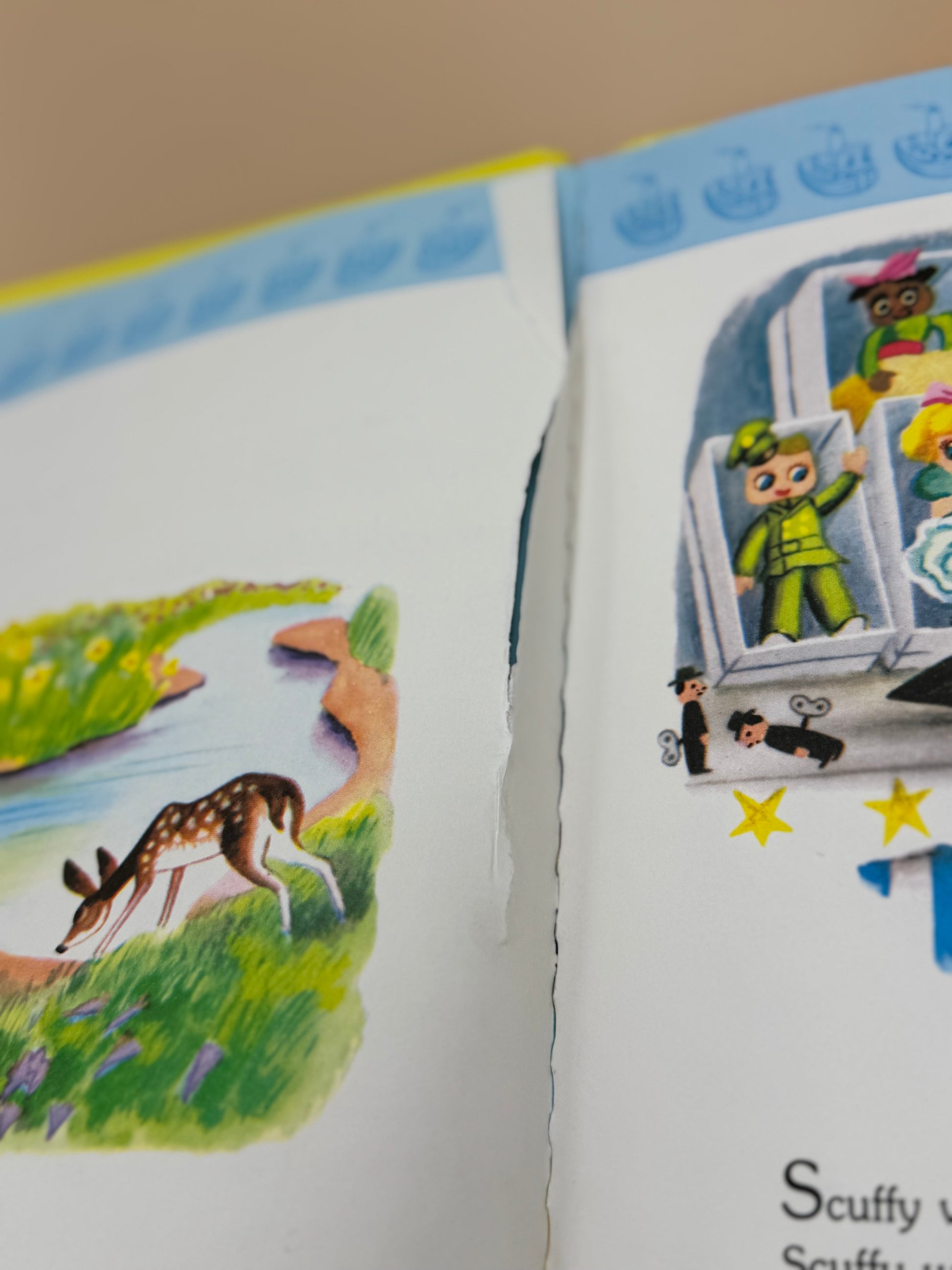Children's book open to a page with illustrations of a deer and characters in a vehicle.