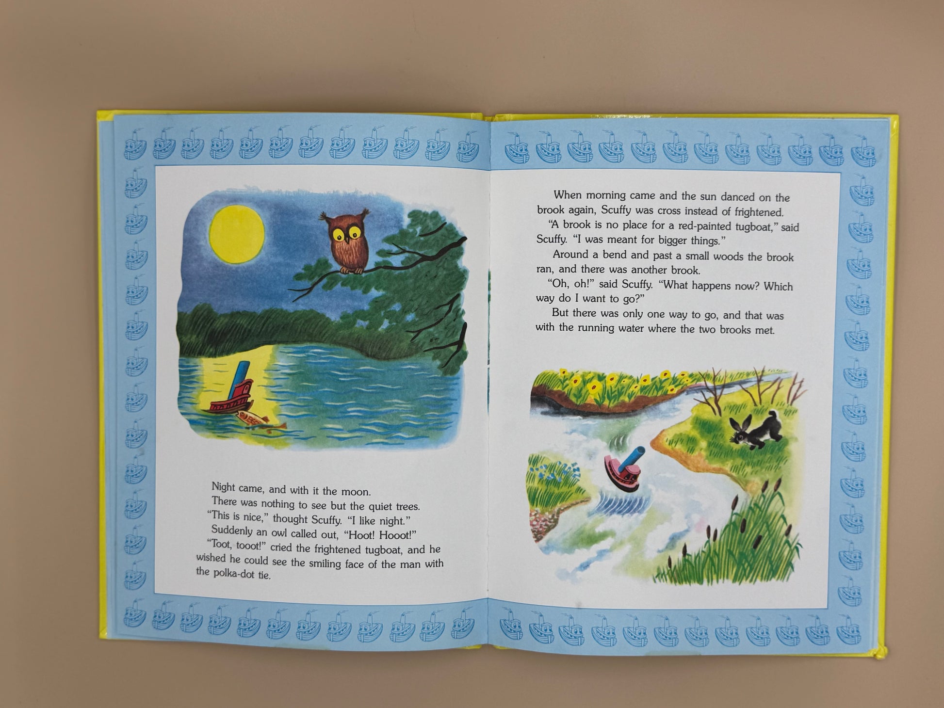 Open book with illustrations and text on a plain background