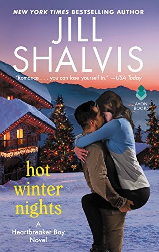 Book cover of 'Hot Winter Nights' by Jill Shalvis with a couple embracing in front of a snowy cabin.
