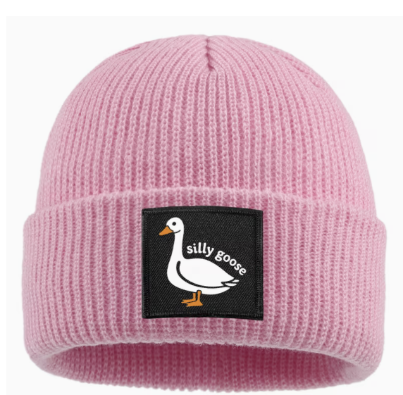 Pink ribbed knit winter beanie with folded cuff and black Silly Goose patch featuring a white cartoon goose