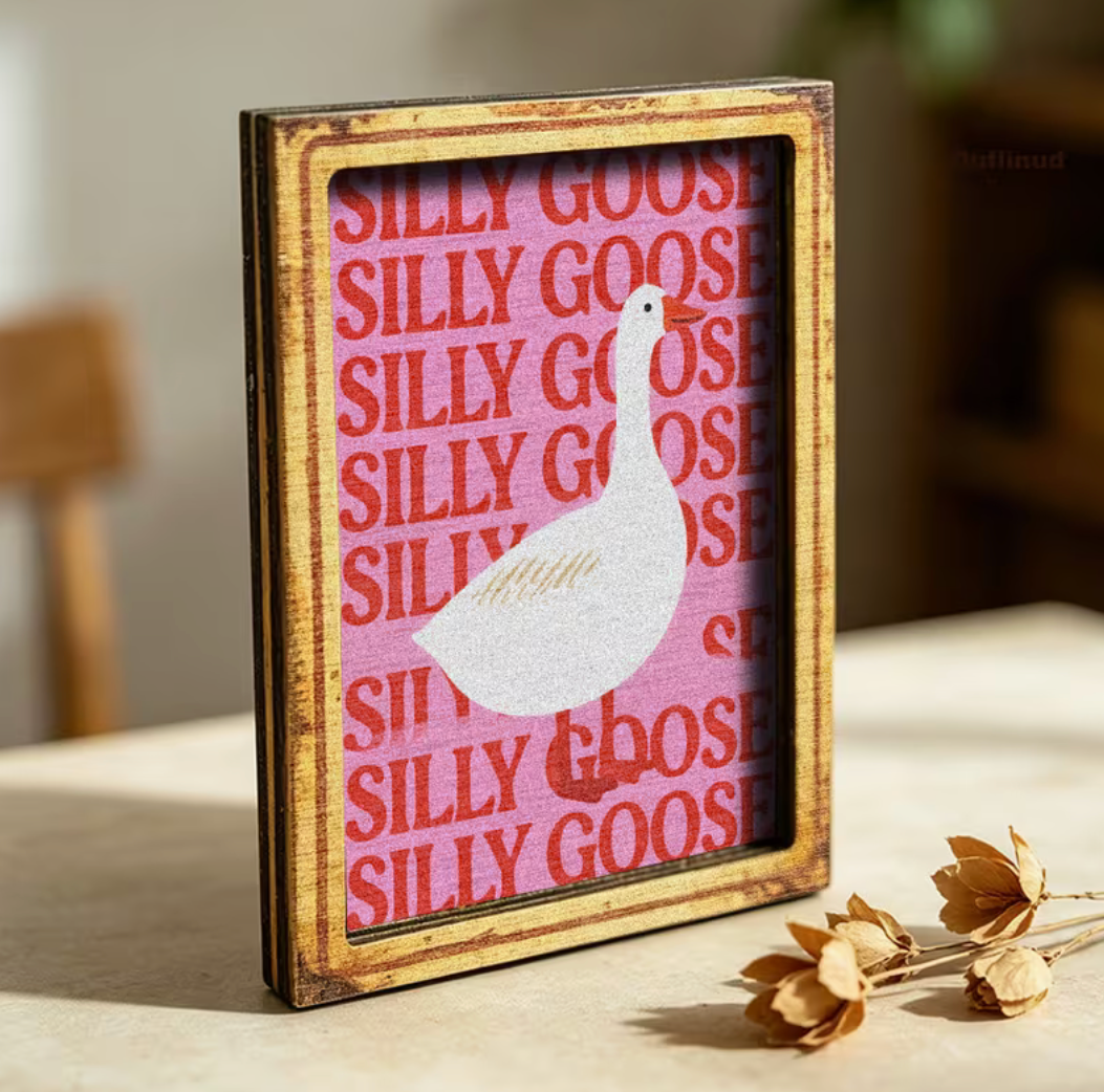 Wooden refrigerator magnet featuring a white goose with a pink Silly Goose background, perfect for kitchen decor and gifts.