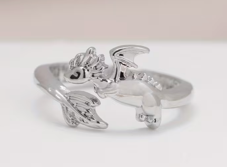 Close up of silver tone adjustable dragon ring showing detailed wings, curved body, and fantasy dragon design