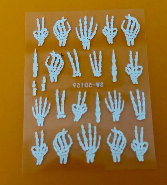 Sheet of white skeleton hand stickers on a clear backing with an orange background.
