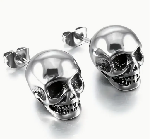 Silver skull-shaped earrings on a white background
