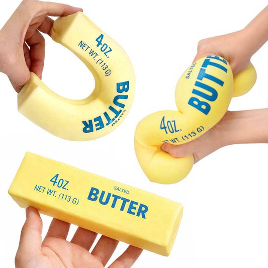 Hands squeezing slow rising butter stick squishy toy