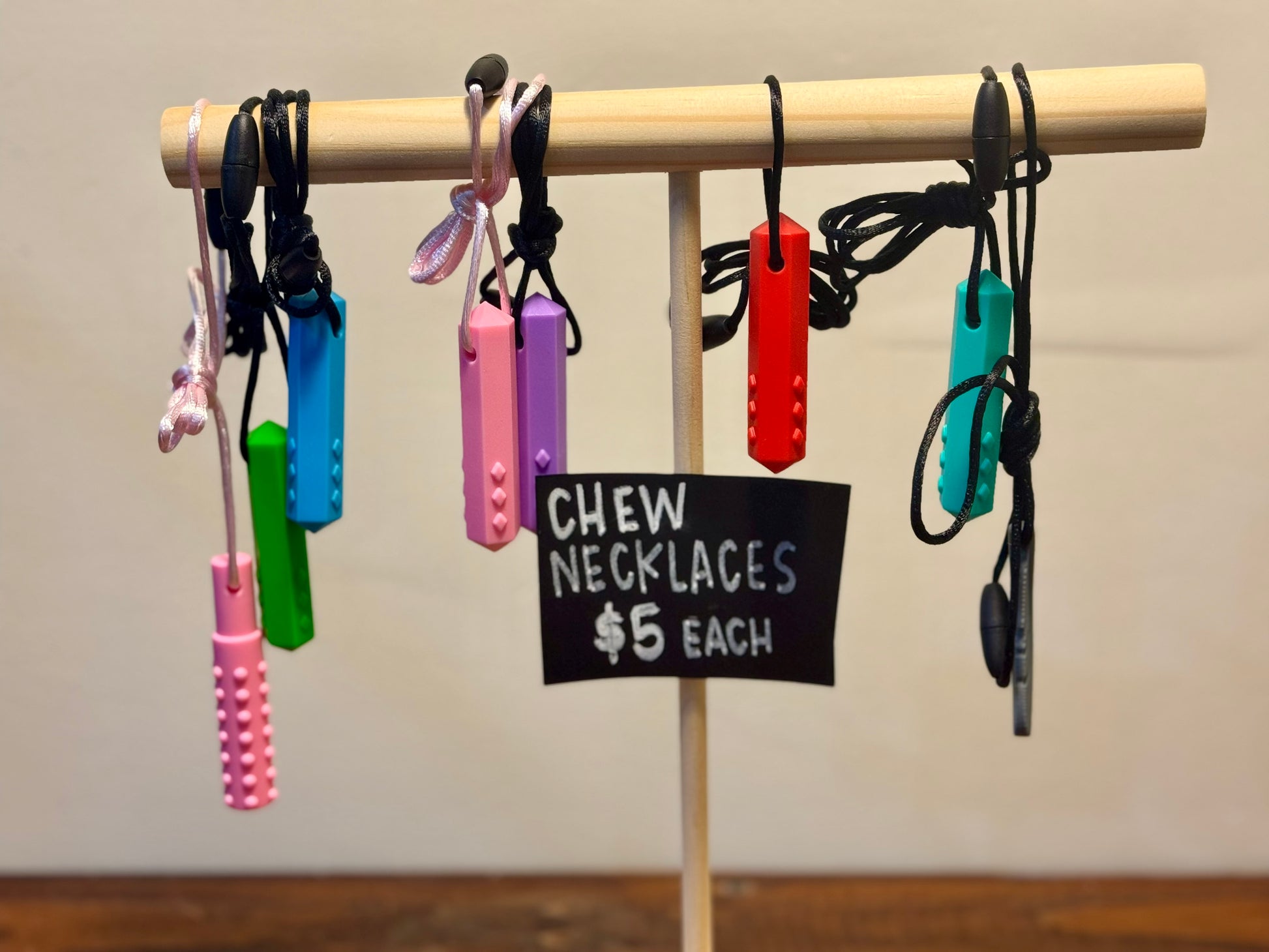 A colorful set of sensory chew necklaces in various shapes and designs, ideal for kids and adults needing oral sensory input.