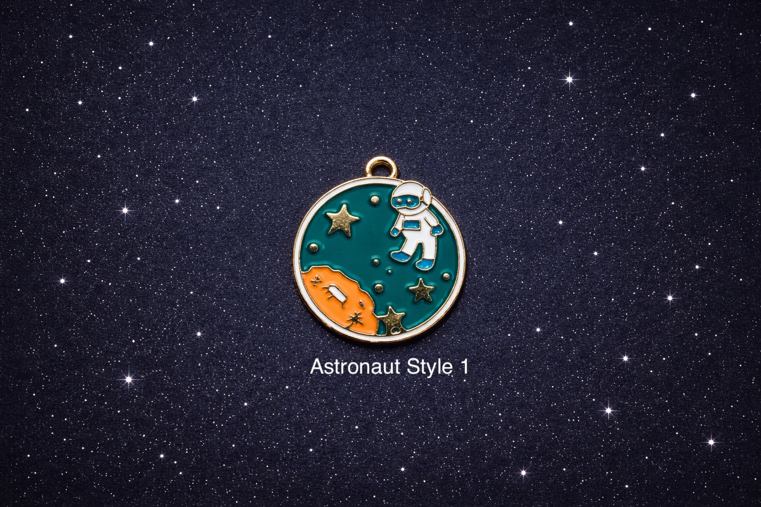 Round enamel space charm with a small astronaut floating over a teal and orange planet with gold stars, shown on a dark starry background and sold individually.