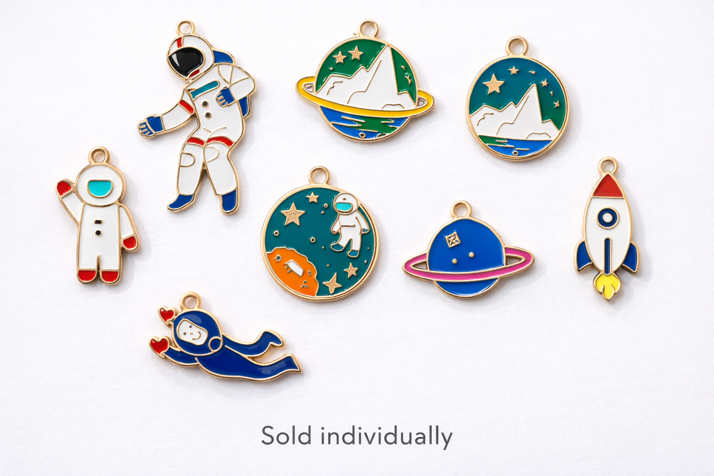 Collection of space enamel charms showing astronauts, rockets, planets and galaxy designs on a white background, charms sold individually for jewelry and keychain making
