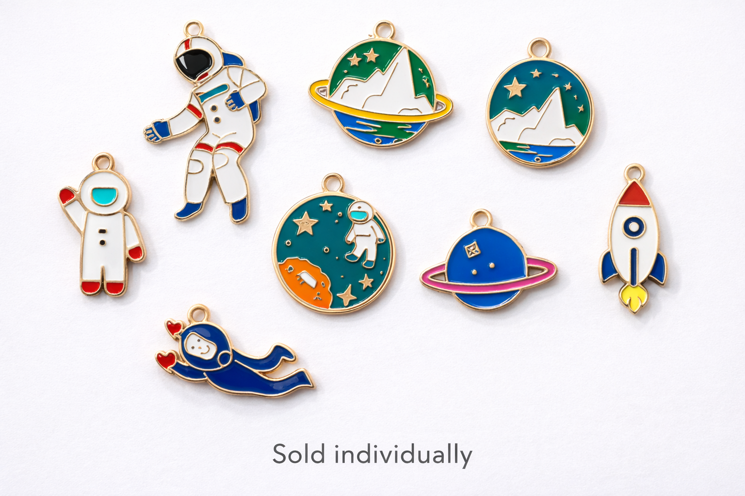 Collection of space enamel charms showing astronauts, rockets, planets and galaxy designs on a white background, charms sold individually for jewelry and keychain making