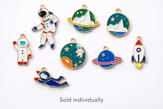 Collection of space enamel charms showing astronauts, rockets, planets and galaxy designs on a white background, charms sold individually for jewelry and keychain making