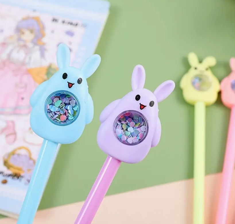 A sparkling bunny gel pen featuring a glittery bunny-shaped topper, sleek design, and smooth-flowing quick-drying ink, perfect for journaling and note-taking.