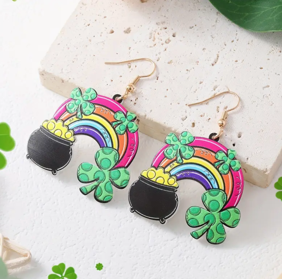 A pair of St. Patrick’s Day acrylic earrings featuring a colorful rainbow, a pot of gold, and a four-leaf clover, perfect for festive celebrations.