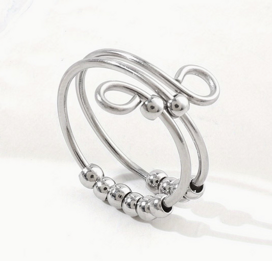 Stainless steel multi band fidget ring with sliding beads and an open wrap design on a white background