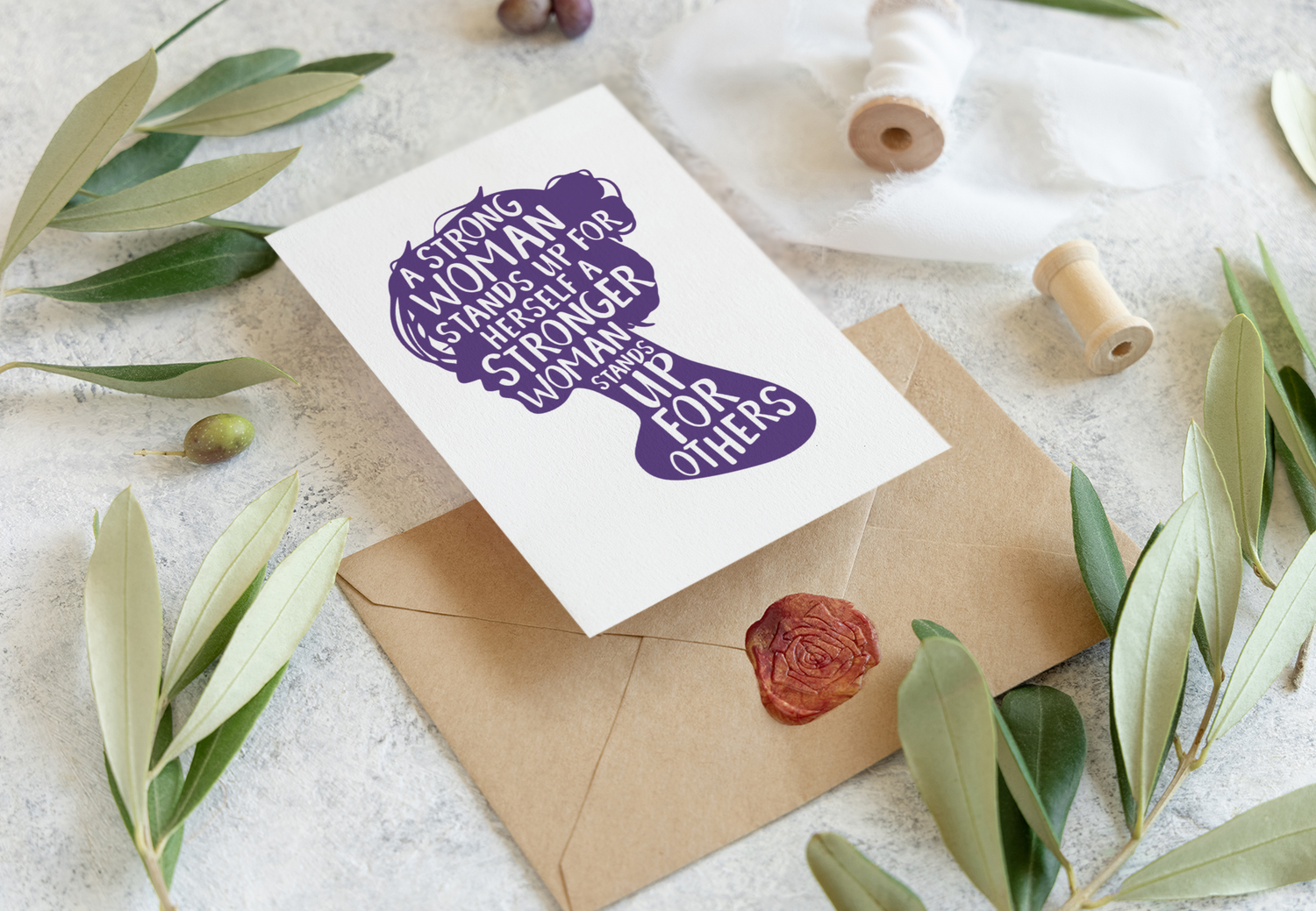 A Women’s History Month greeting card featuring the silhouette of a woman’s head and the empowering quote: A strong woman stands up for herself. A stronger woman stands up for others.