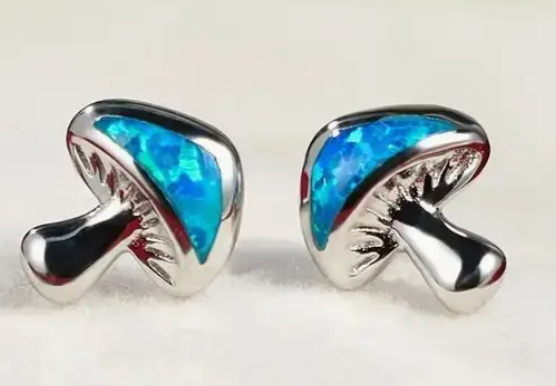Pair of small blue mushroom stud earrings with whimsical forest-inspired design, enchanting fairycore jewelry