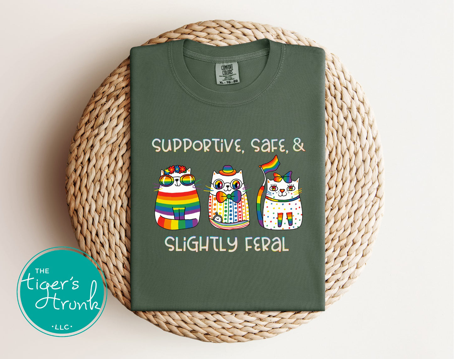 Green t-shirt with owl design and text on a woven mat, featuring 'The Tiger's Trunk' logo.