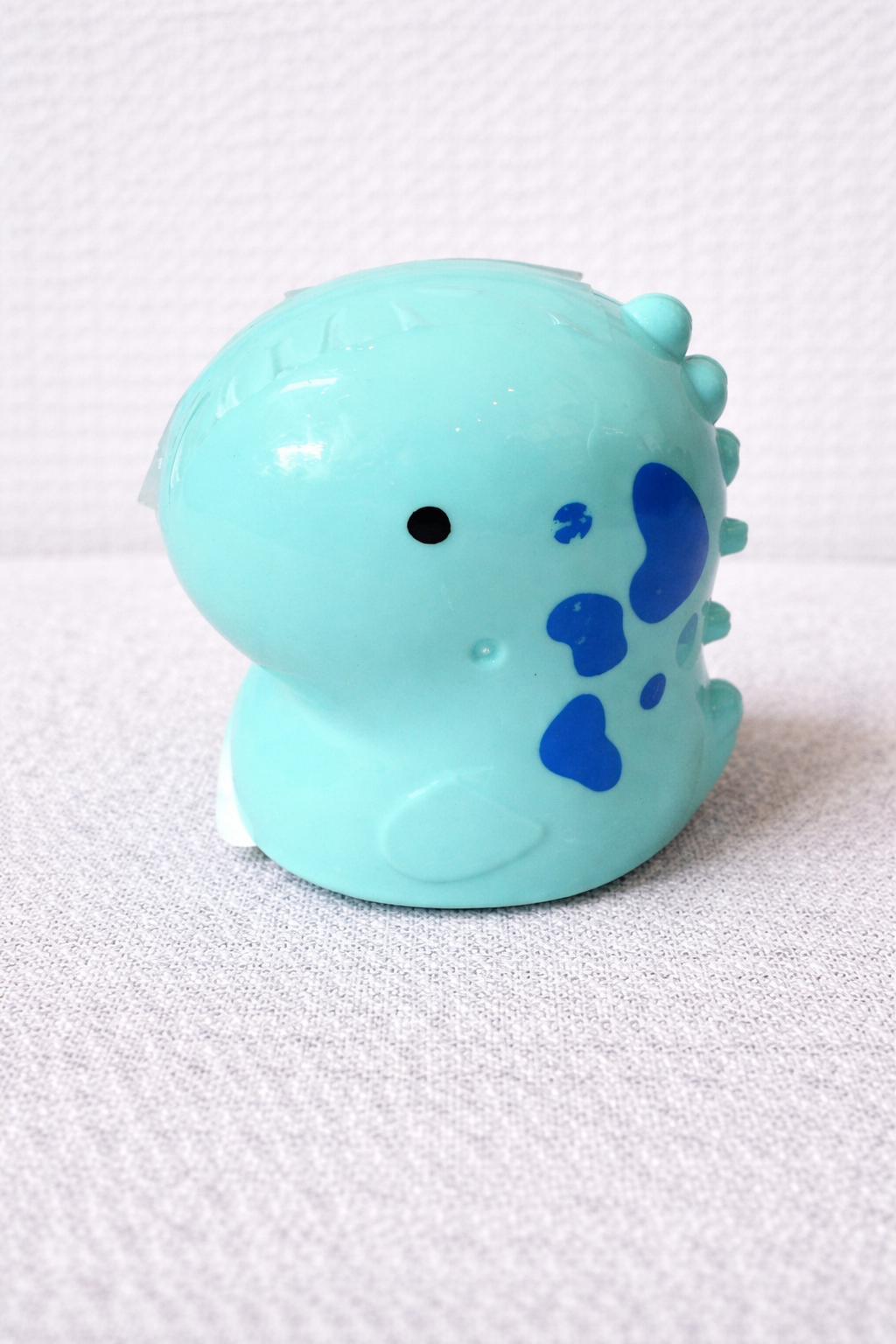 Light blue toy with blue accents on a white background