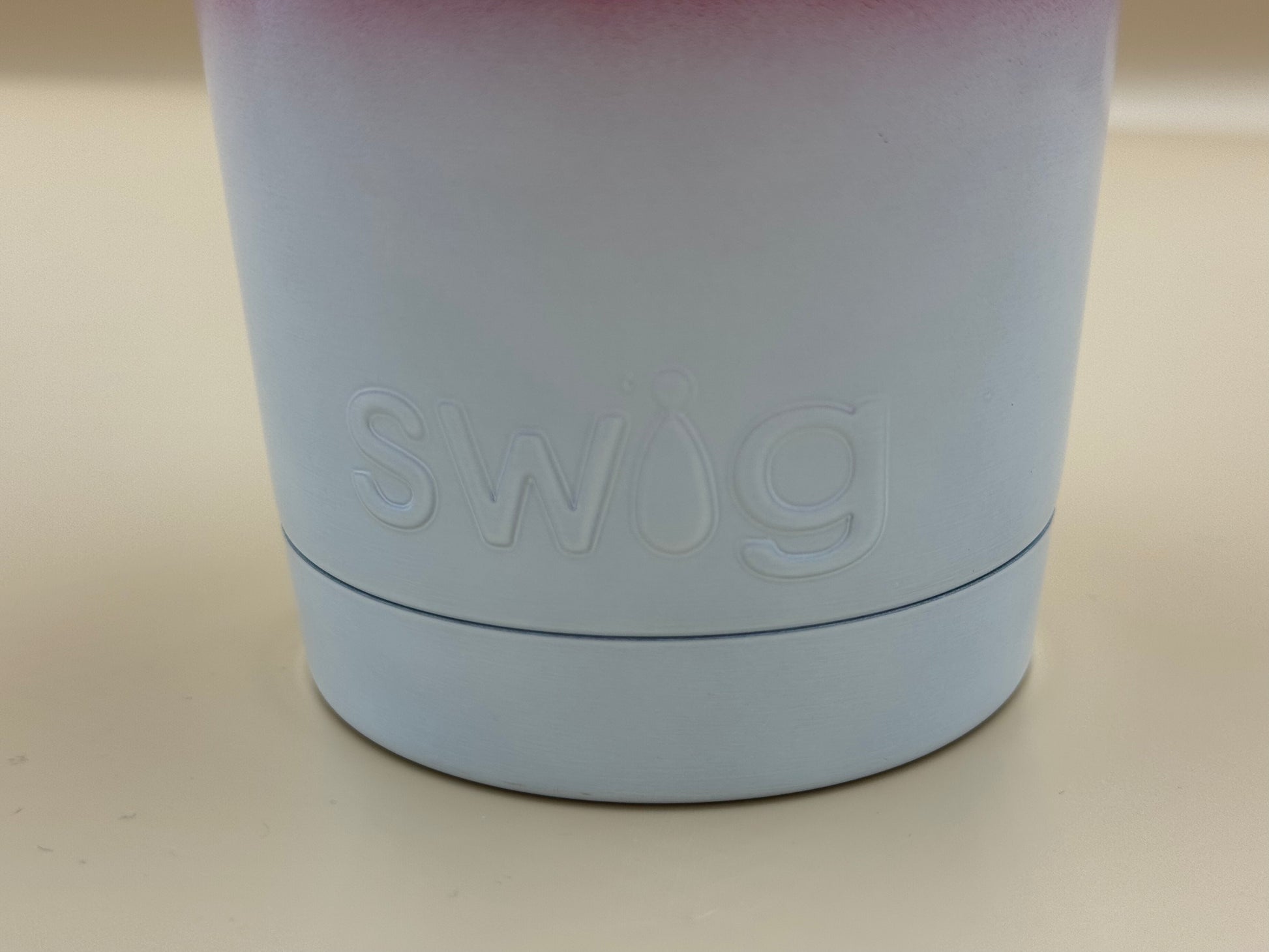Light purple tumbler with 'swig' branding on a beige background
