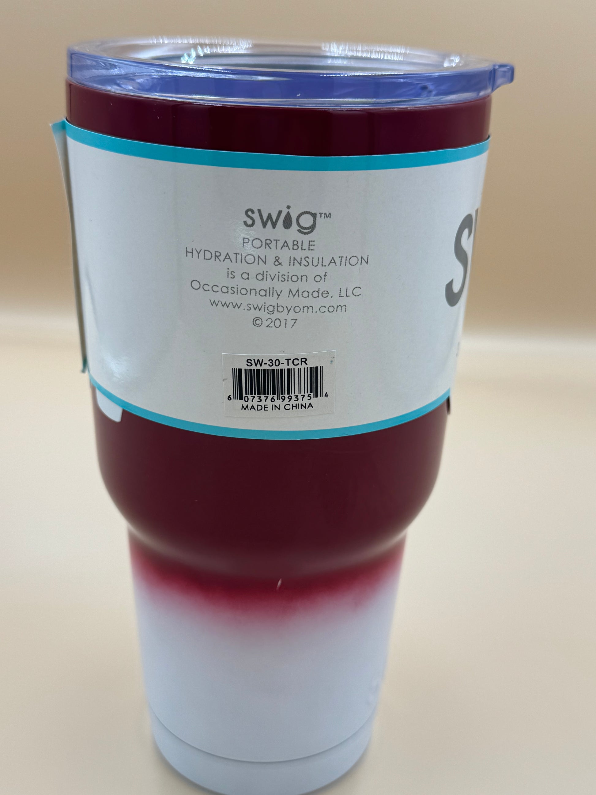 Swig tumbler with gradient design on a beige background