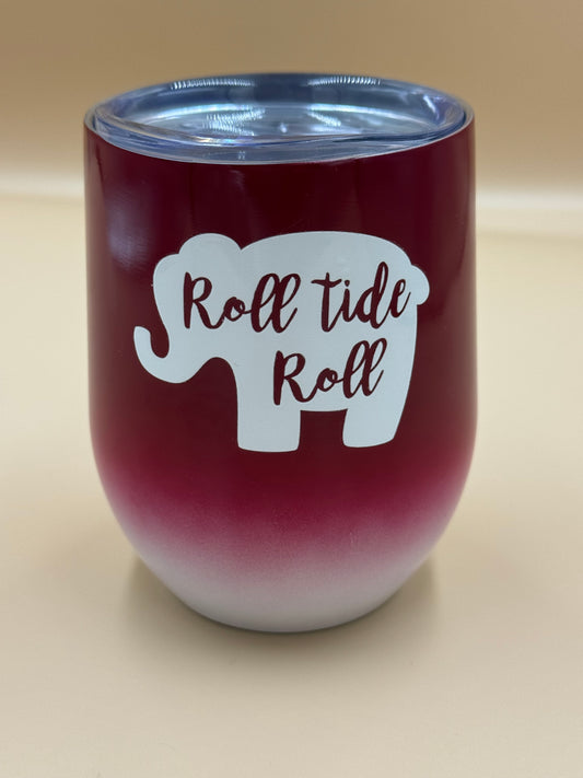 Maroon tumbler with 'Roll tide Roll' design on a beige background