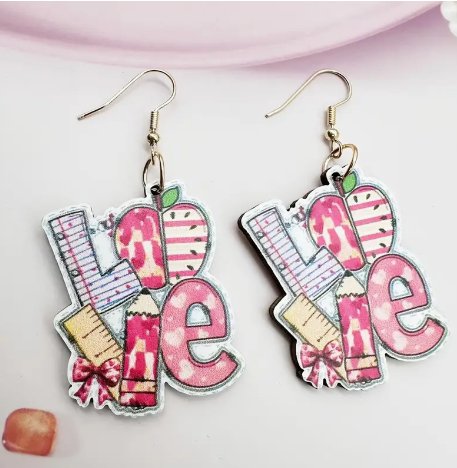 Pair of wooden earrings spelling out the word LOVE using school supplies like pencils, rulers, and apples—perfect for teachers and classroom wear.