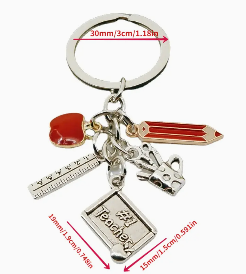Metal keychain featuring a red pencil and apple, silver ruler, mug with writing utensils, and a plaque that says #1 Teacher—a thoughtful gift for educators.
