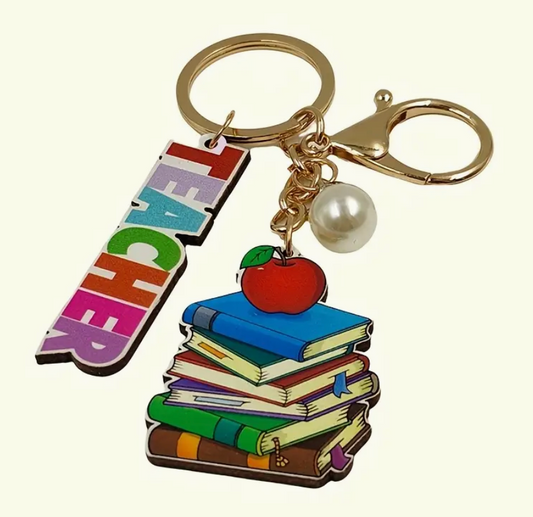 Wooden keychain engraved with the word Teacher and an illustration of a stack of books—perfect for showing appreciation to educators.
