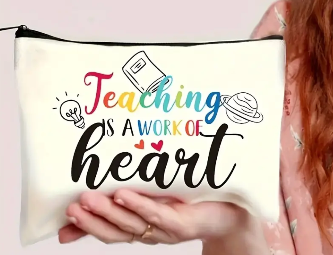 Canvas accessories pouch with the phrase Teaching Is a Work of Heart printed in decorative lettering—perfect for teachers.