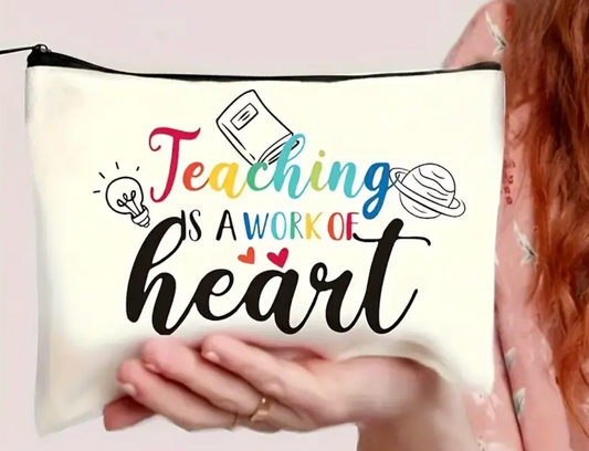 Canvas accessories pouch with the phrase Teaching Is a Work of Heart printed in decorative lettering—perfect for teachers.