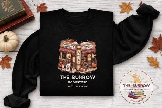 Black The Burrow Bookstore fall sweatshirt with cozy autumn bookstore and pumpkin design