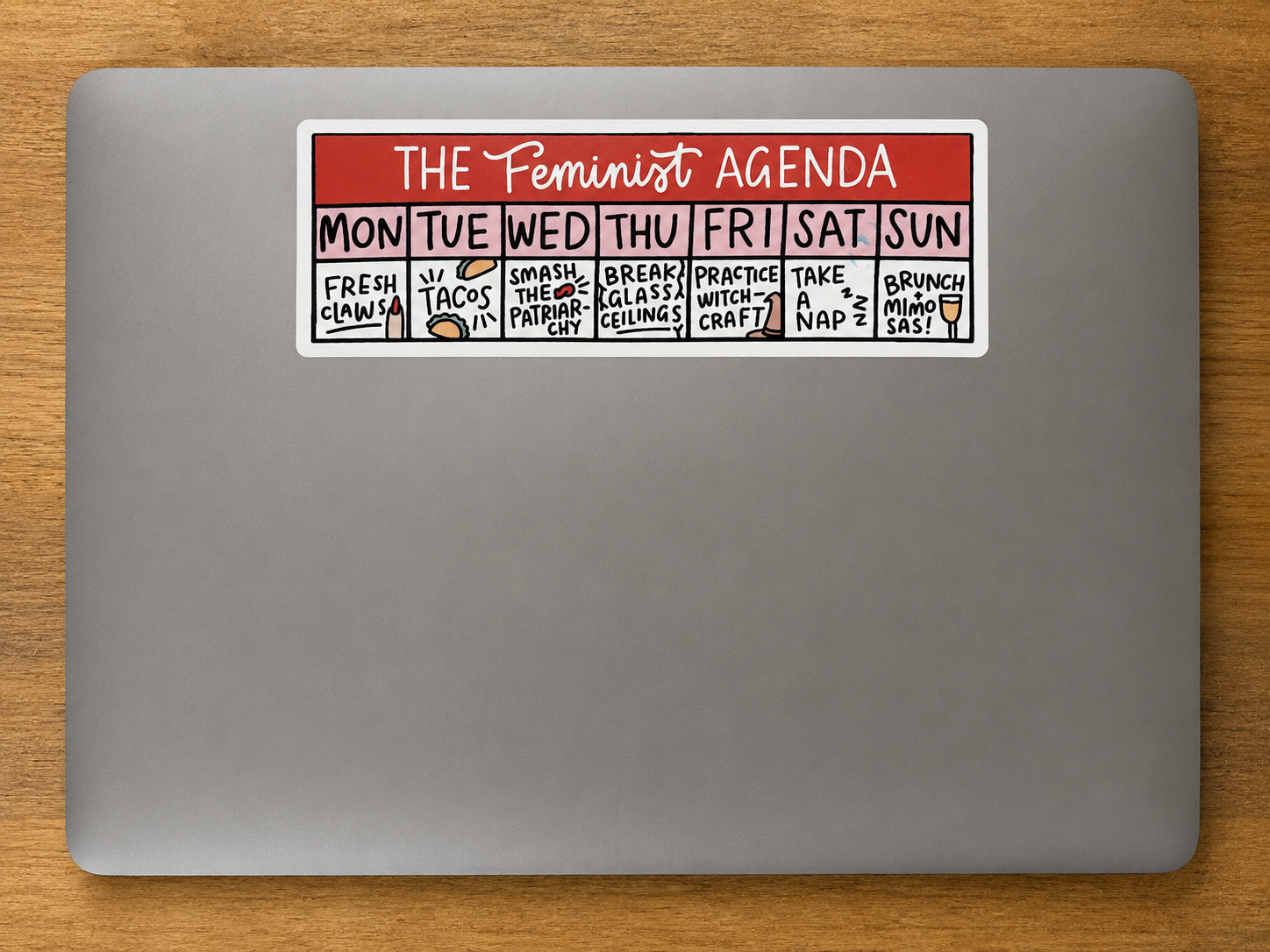 Rectangular die cut sticker featuring a humorous Feminist Agenda weekly planner design displayed on a laptop.