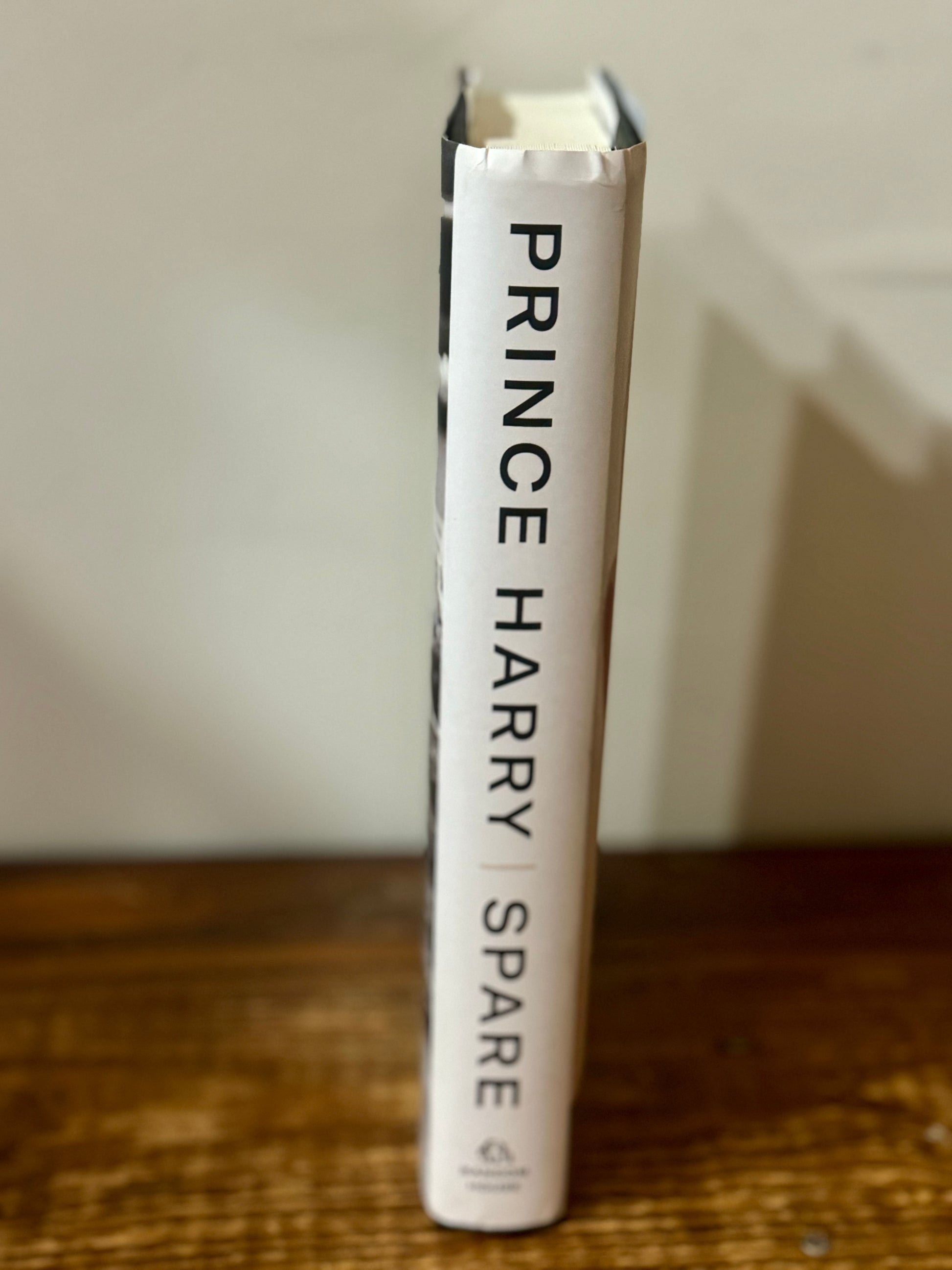 Hardback copy of Spare by Prince Harry Jr., ghostwritten by J.R. Moehringer, in like new condition, a royal memoir.