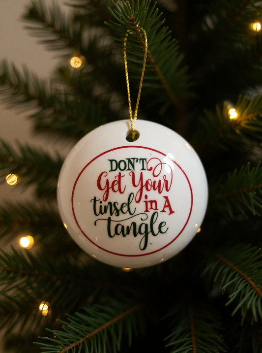 Christmas ornament with text 'Don't get your tinsel in a tangle' on a tree.