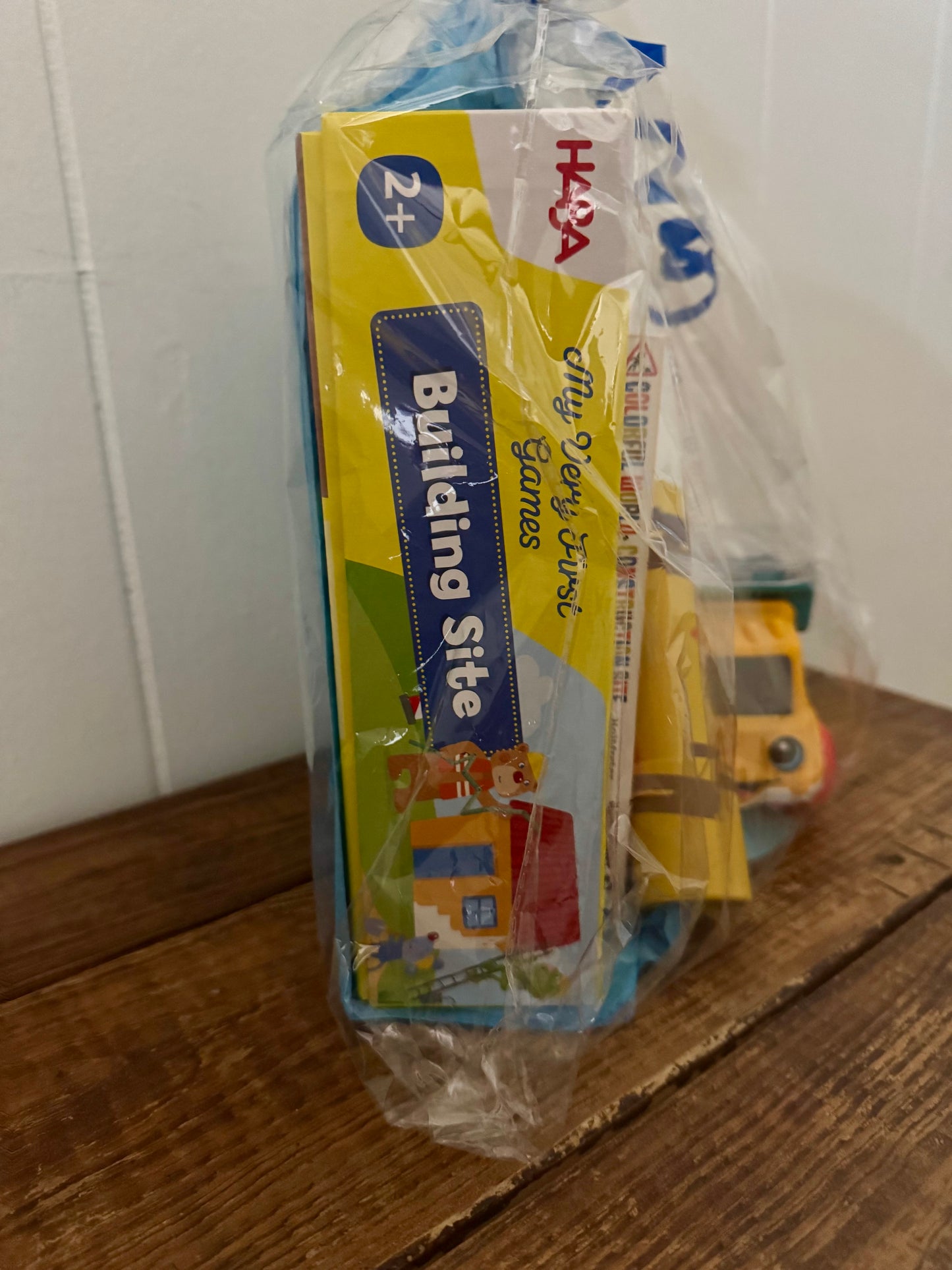 Toy construction set with packaging labeled 'Building Site' on a wooden surface.