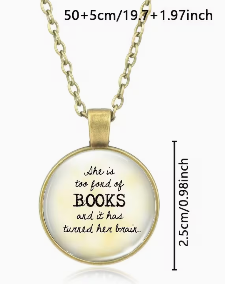 A gold-tone pendant necklace with a round glass-domed charm featuring the quote 'She is too fond of BOOKS and it has turned her brain.' in black text.