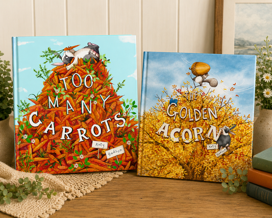 Too Many Carrots and The Golden Acorn by Katy Hudson displayed side by side on a wooden table with greenery, stacked books, and a warm cozy background, highlighting the companion children's picture books.
