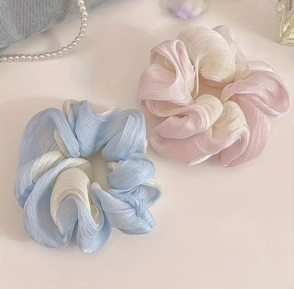 Small two-tone fabric scrunchies in pastel blue and white and blush pink and cream