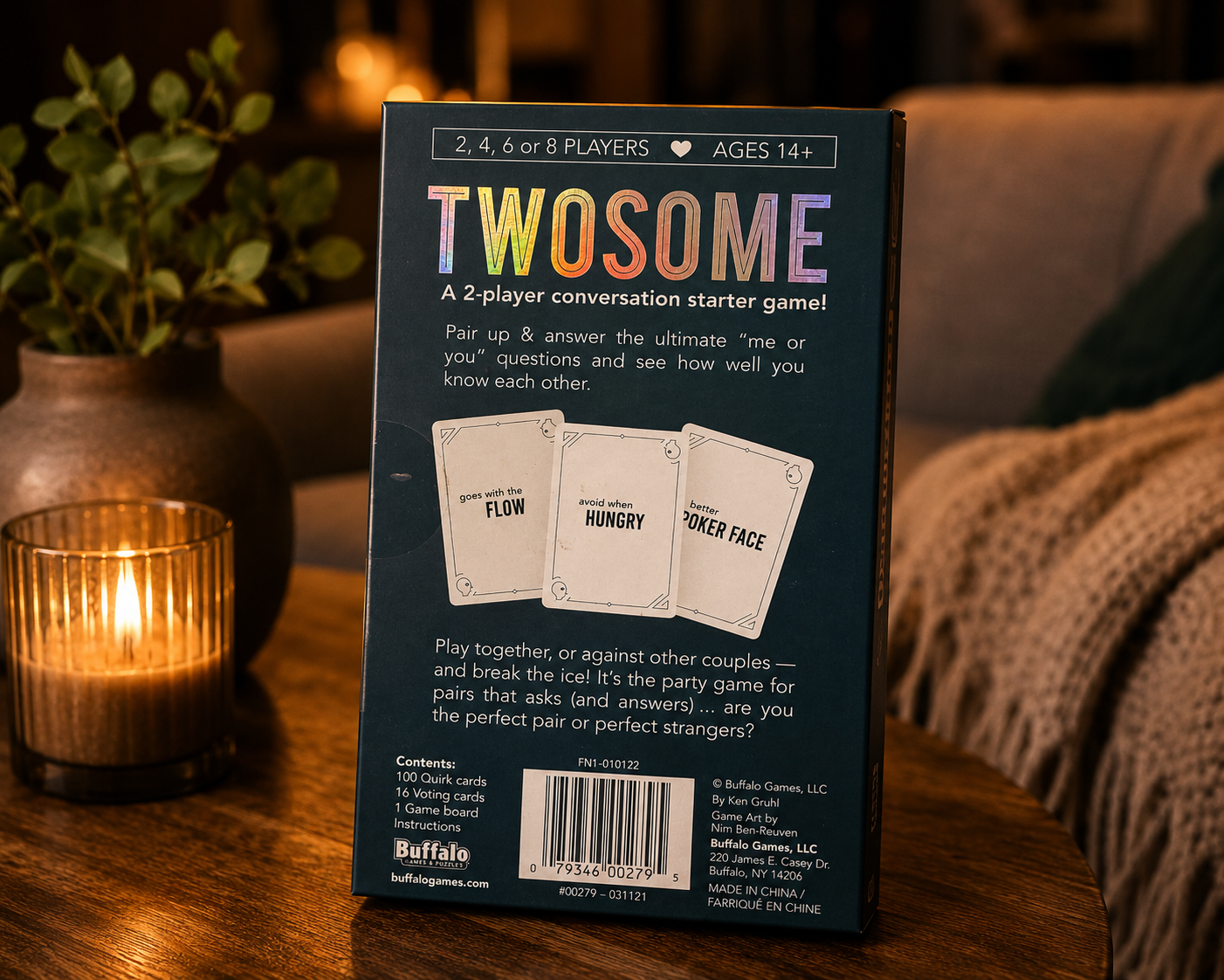 Back of a 'Twosome' game box on a wooden table with a candle and plant in the background