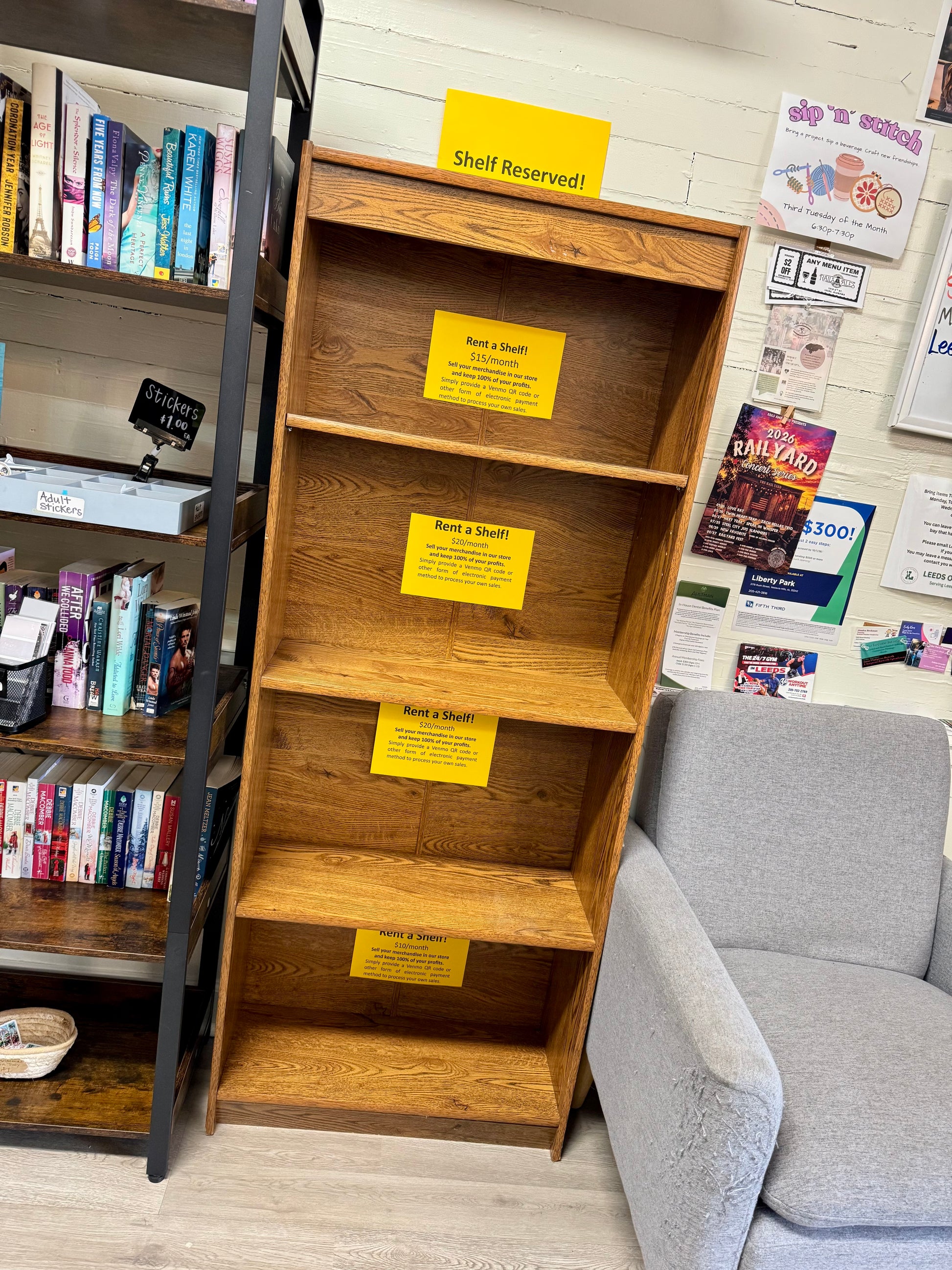 Vendor shelf rental display located beside bookstore seating area and community bulletin board.