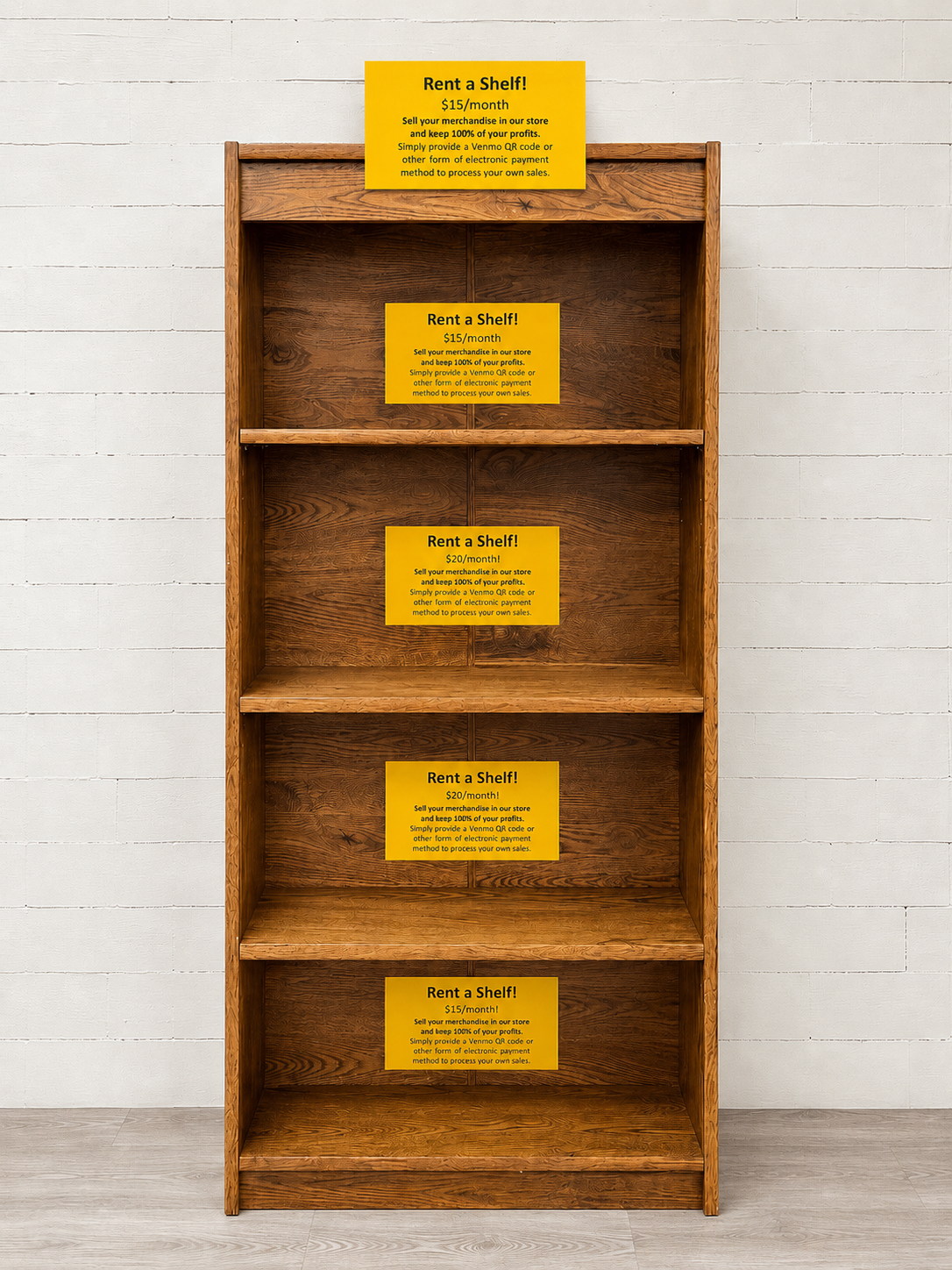 Front view of wooden vendor shelf display available for monthly rental inside an independent bookstore.