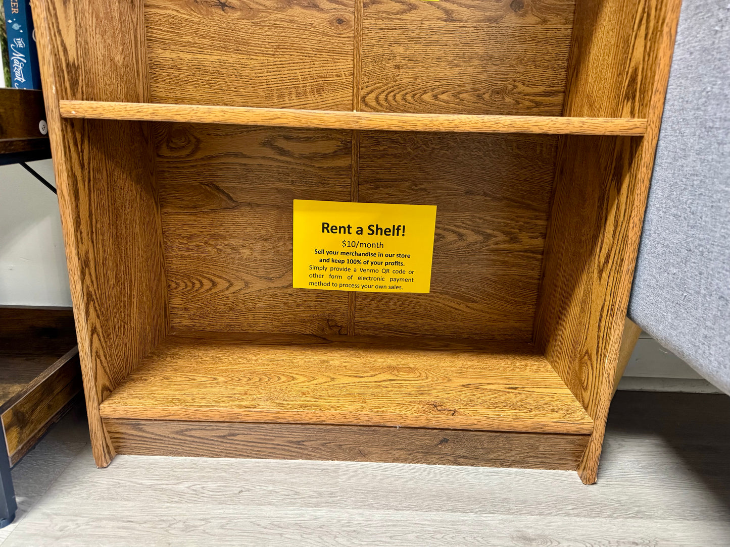 Bottom vendor shelf available for rent for $10 per month in independent bookstore.