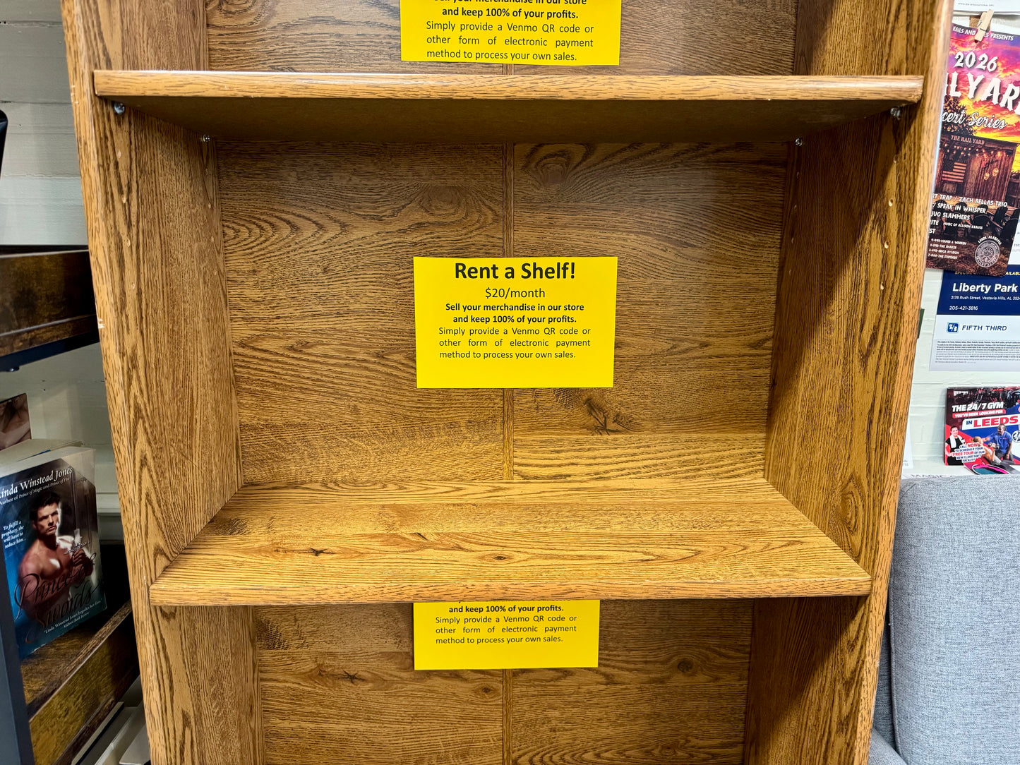 Middle vendor shelf available for rent at $20 per month inside bookstore display.