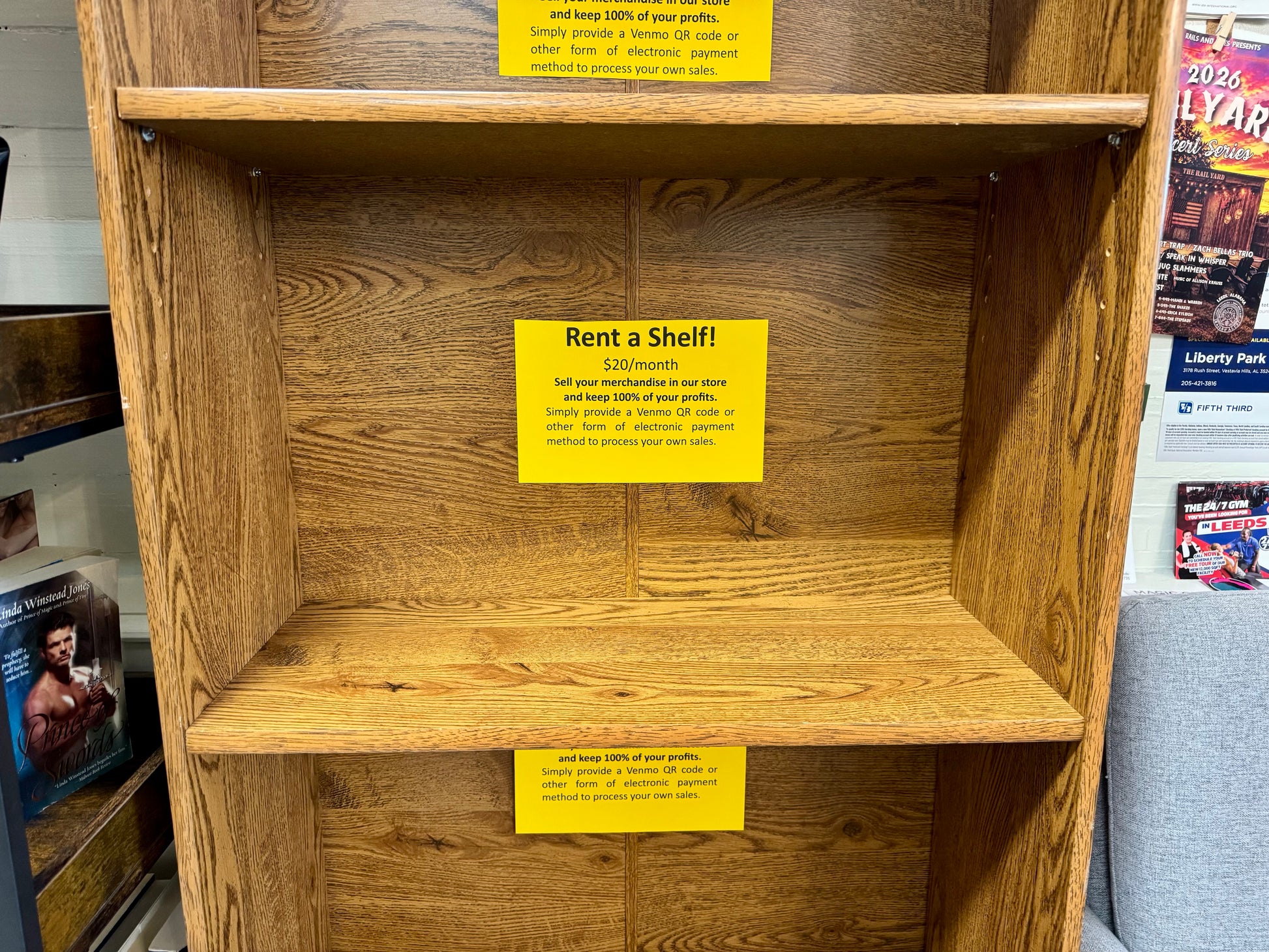 Middle vendor shelf available for rent at $20 per month inside bookstore display.